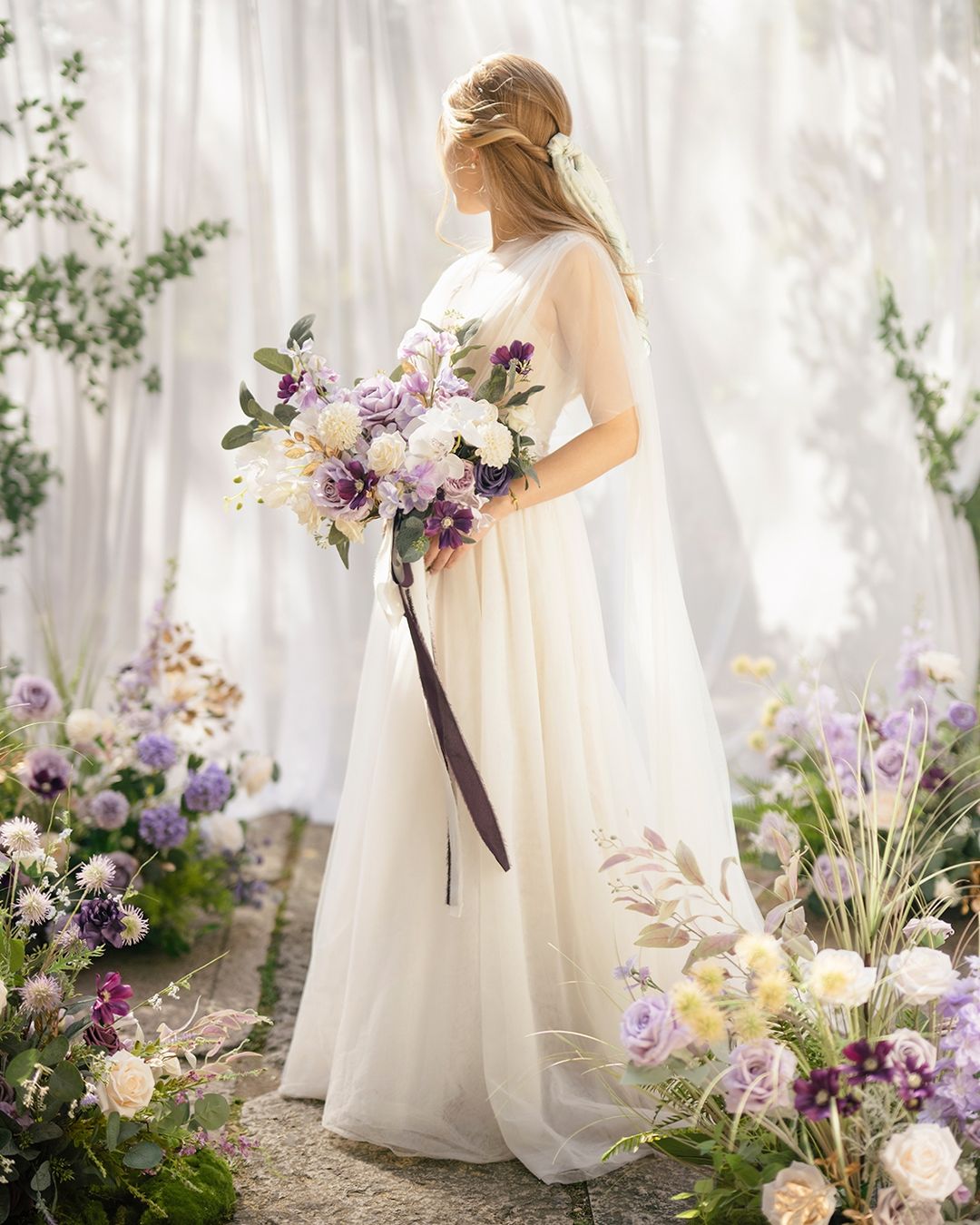 This is a bridal bouquet consisting of roses, morning thistles and other fresh flowers. The bouquets are white and pink and decorated with ribbons and garlands. Bouquets are perfect for brides looking for an elegant and romantic accessory.
