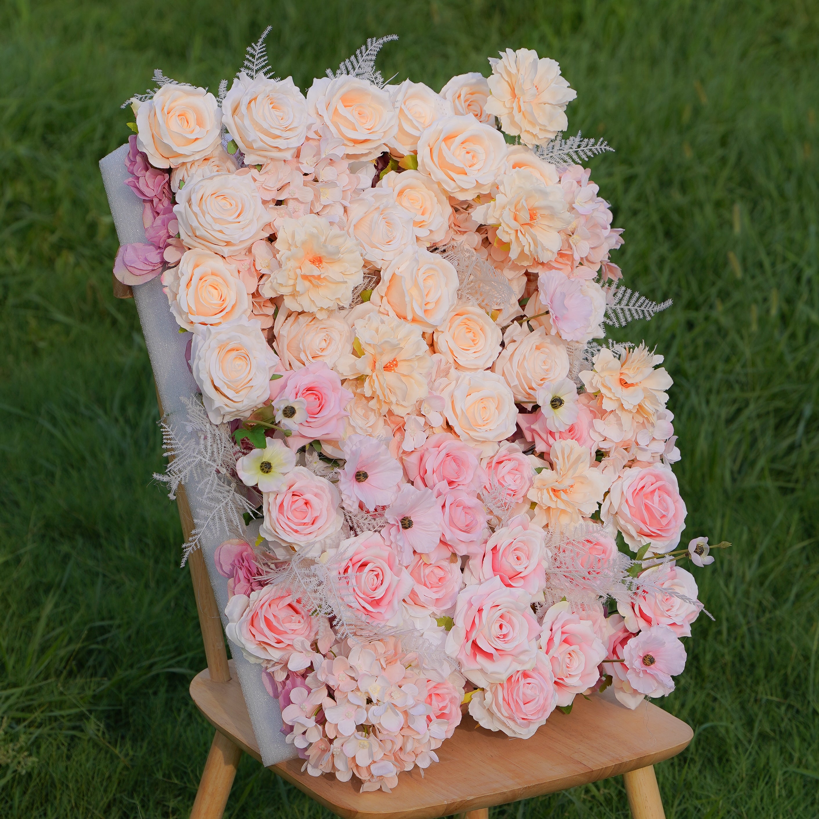 This is a photo of a rose morning danilia wall. The flower wall is made of 5D fabric, hand rolled and measures 8ft x 8ft. The flower wall is composed of bright roses, creating a romantic and elegant atmosphere. The flower wall is suitable for various occasions, such as weddings, parties, birthday parties, etc. It is also perfect for decorating your home.