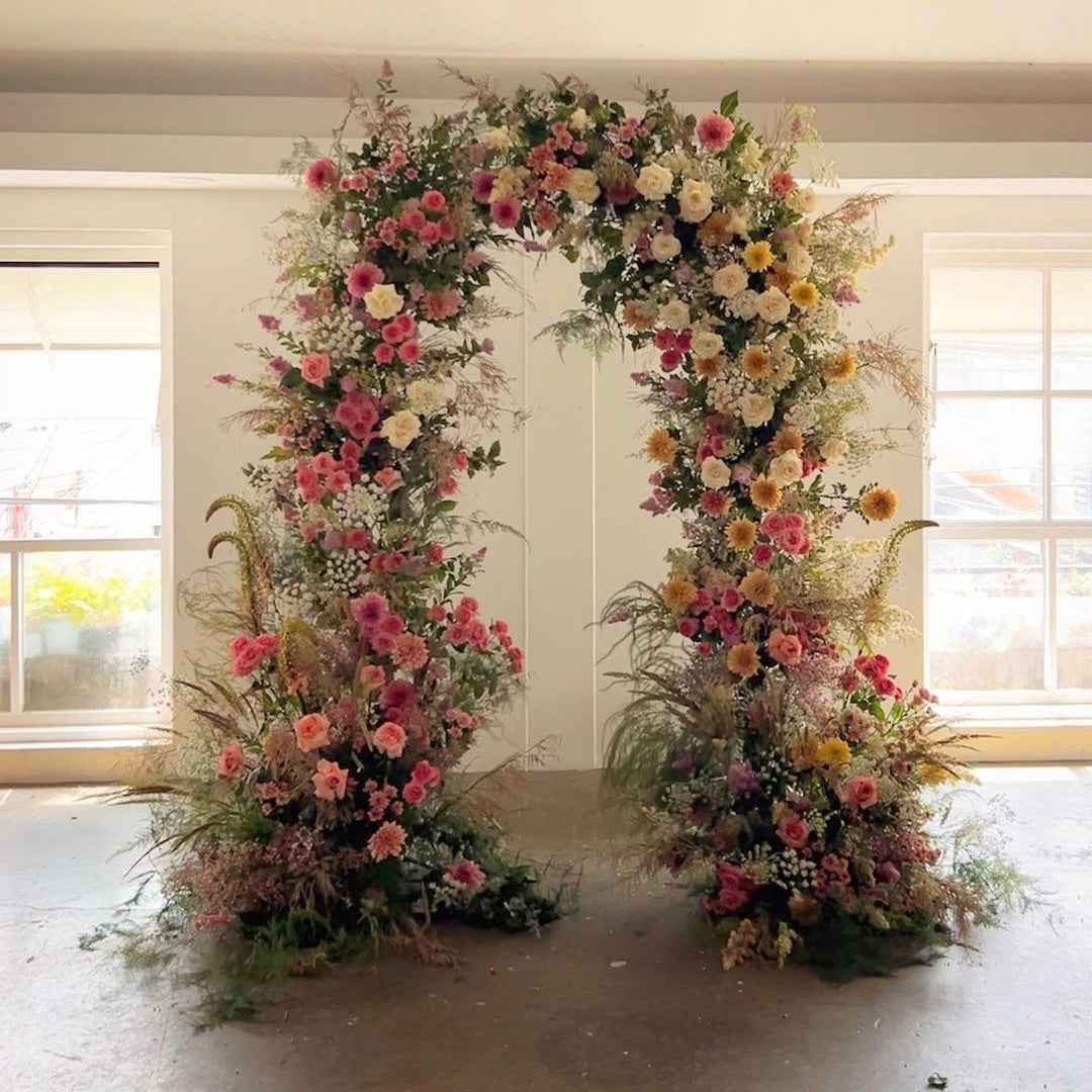 Rose morning Demi : 2023 New Wedding Party Background Floral Arch Decoration Including Frame -R872 is a beautiful wedding floral arch decoration photo. The arch is made of flowers and green leaves with a golden frame on it. The flowers are red, pink and white and exude a romantic vibe. Arches are the perfect backdrop for a wedding party and are sure to wow your guests.